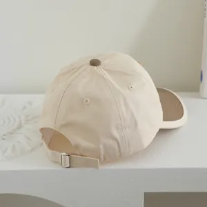 Adjustable beige children's baseball cap with brown brim and bear-style cartoon design