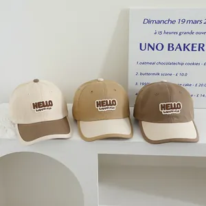 Three color options of children's cotton baseball caps with Hello embroidery details