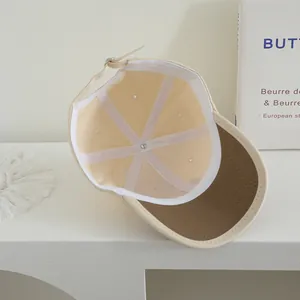 Detail view of cotton baseball cap interior featuring durable six-panel stitching and metal buckle