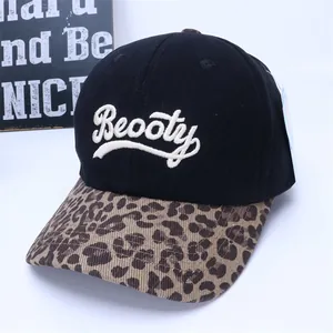 Close-up of black baseball cap featuring leopard print brim and white Beooty embroidery