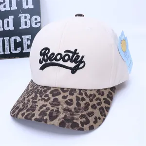 Close-up of beige canvas baseball cap with leopard print brim and Beooty 3D embroidery
