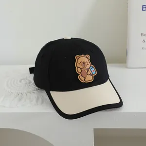 Detailed view of kids baseball cap featuring a cute cartoon bear patch and color-block brim