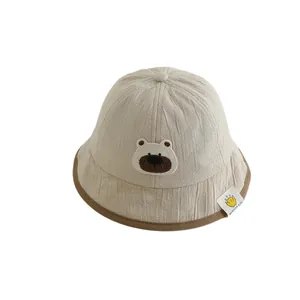 Cute beige baby sun hat with brown bear embroidery and a soft stylish brim