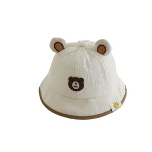 Cream white baby sun hat with cute bear ears and embroidered brown bear face design