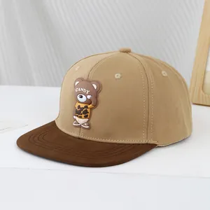 Detail of khaki baseball cap with a cute bear patch and flat brim for kids and youth