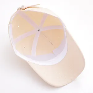 Internal view of beige kids baseball cap showing sweatband and adjustable back strap
