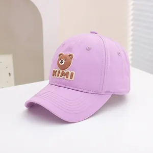 Detail of lavender baseball cap featuring a cute brown bear patch and KIMI embroidery