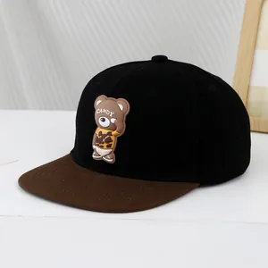 Detail view of hip-hop flat brim cap featuring 3D cartoon bear patch with CANDY text