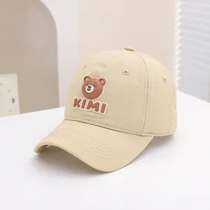 Detail of a khaki kids baseball cap with a 3D brown bear silicone patch and KIMI text