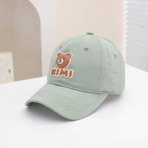 Detailed close-up of bean green kids baseball cap with 3D cartoon bear and KIMI patch