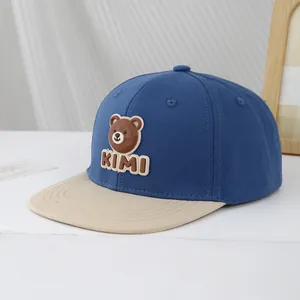 Close-up of kids baseball cap with 3D bear patch and KIMI embroidery detail