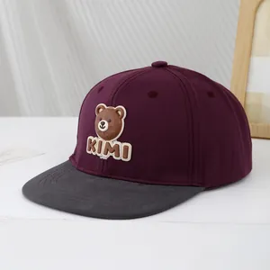 Kids flat brim baseball cap featuring KIMI bear patch in purple and grey colors