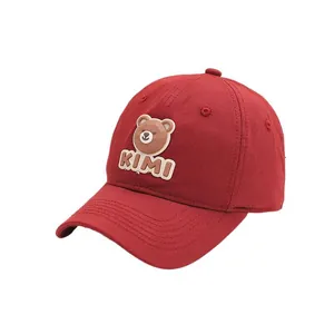 Deep red cotton baseball cap with cartoon bear embroidery and KIMI text on white background