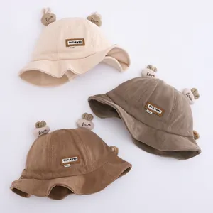 Close-up of soft corduroy fabric kids bucket hats with cute bunny ears and leather patch