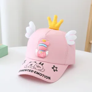 Détail casquette rose pour enfant avec couronne jaune, ailes blanches et patch ours
