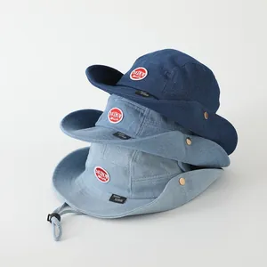 Three shades of denim bucket hats with red label patch and adjustable chin strap