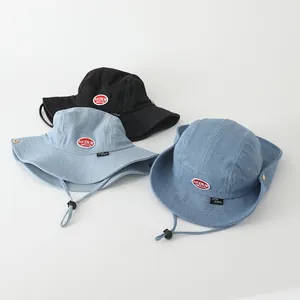 Kids denim bucket hat with adjustable chin strap in black and blue colors