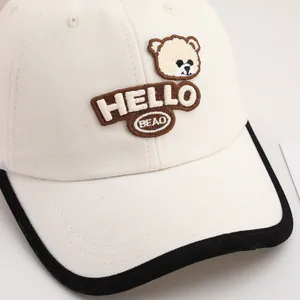 Detailed embroidery of cartoon bear and HELLO text on premium cotton baseball cap