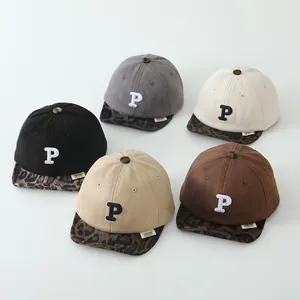 Five assorted colors of suede-textured kids' baseball caps with leopard print brims and P embroidery