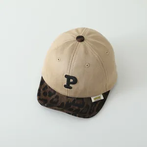 Close-up of khaki suede baby cap featuring a leopard print brim and embroidered P letter