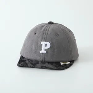 Detail of grey baby baseball cap with leopard brim and white P letter embroidery