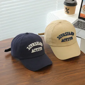 Detailed embroidery of 'LIVELY AND ACTIVE' on navy and beige cotton baseball caps