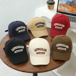 Detailed embroidery view of multi-color cotton baseball caps with adjustable straps