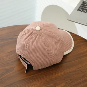 Detail of adjustable strap and pink corduroy texture on children baseball cap