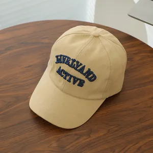 Close-up of navy blue embroidered LIVELY AND ACTIVE text on beige canvas baseball cap