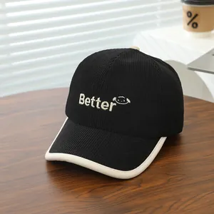 Detail of black corduroy baseball cap featuring Better embroidery and contrast brim edge