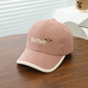 Close-up of pink corduroy kids baseball cap with Better embroidery and white fabric brim