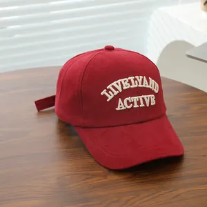 Detailed view of white Lively and Active 3D embroidery on red cotton baseball cap
