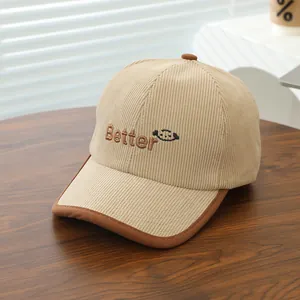 Close-up of kids corduroy baseball cap with Better embroidery and cartoon smiley face