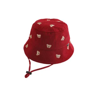 Deep red corduroy bucket hat for toddlers with embroidered bears and windproof strap