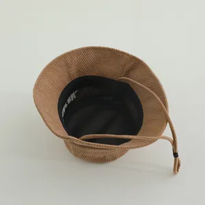 Detail of toddler bucket hat interior showing corduroy fabric mesh lining and chin strap