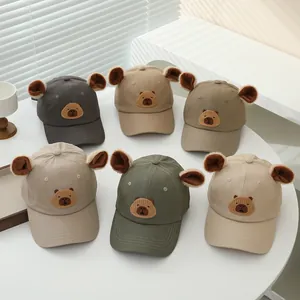 Close-up of cute children's bear baseball caps in six colors with plush 3D ears