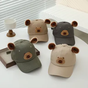 Close-up of four kids' baseball caps with bear ears and fine embroidery details