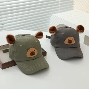 Detail of kids baseball caps featuring 3D plush ears and cute capybara cartoon embroidery