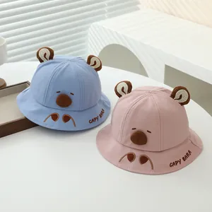 Detailed embroidery of Capybara character on cotton kids sun hats in blue and pink
