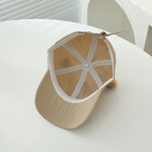 Top view of khaki kids baseball cap showing internal stitching and metal adjustment buckle