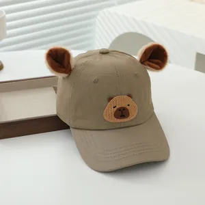 Detail of child baseball cap with plush ears and embroidered cartoon capybara patch