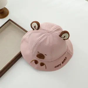 Detailed embroidery of a capybara face and cute brown ears on pink cotton baby sun hat