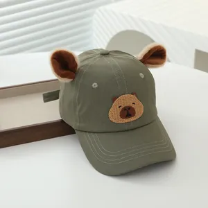 Close-up of military green kids cap featuring cute 3D capybara embroidery and ears