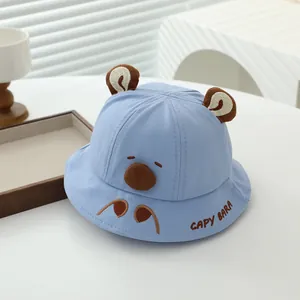 Detail of light blue baby sun hat featuring embroidered capybara face and cute ears
