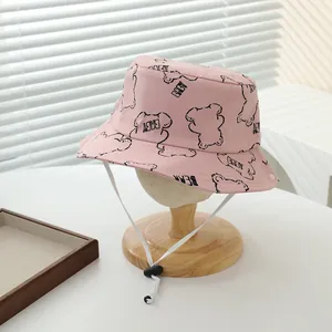 Detalle de gorro de sol rosa para bebé en algodón con dibujos de osos y correa ajustable