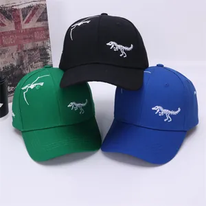 Three kids dinosaur baseball caps in black, green and blue with skeleton embroidery