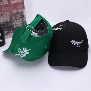 Detail of dinosaur embroidery on black and green cotton baseball caps with metal buckle