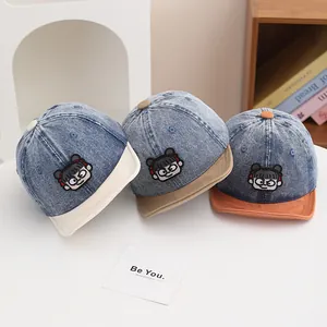 Detailed embroidery of a cartoon girl on washed denim baseball caps for toddlers