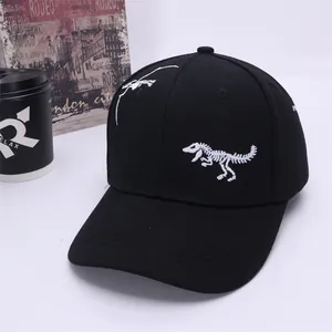 Detailed white dinosaur skeleton embroidery on a black cotton baseball cap for kids