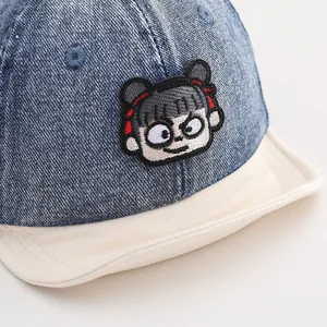 Kids denim baseball cap with navy blue fabric and cartoon character embroidery patch